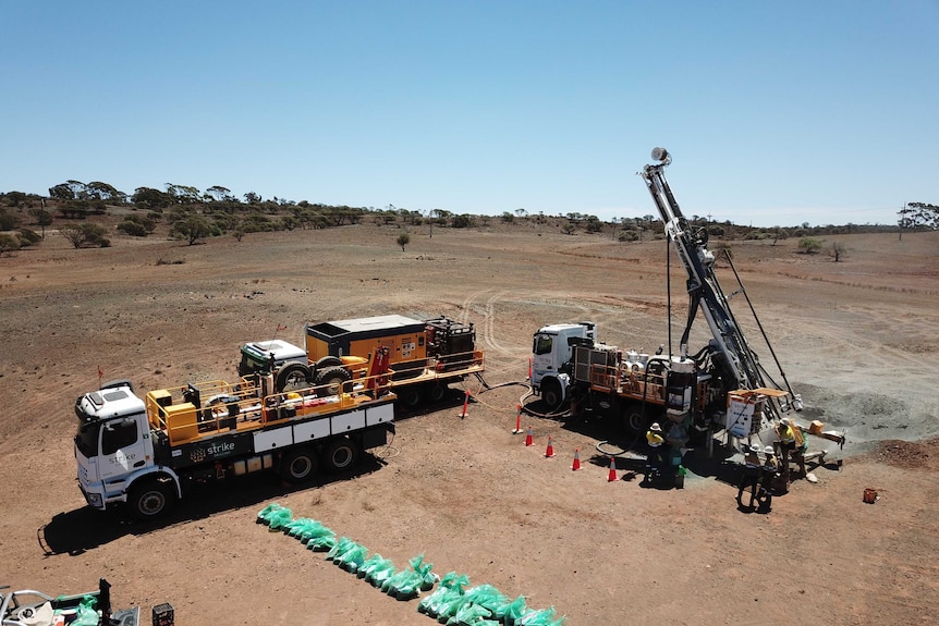 A drone provides an aerial view of a drilling rig working in outback