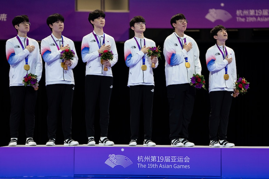 South Korean players place their hands on their hearts after winning gold at the Asian Games.
