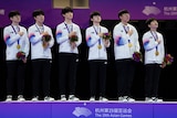 South Korean players place their hands on their hearts after winning gold at the Asian Games.