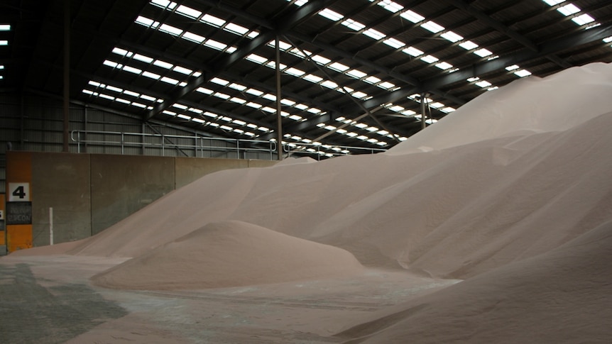 A large pile of sand in a shed.