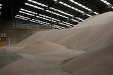 A large pile of sand in a shed.