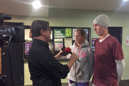 Bruce MacKenzie interviews a young couple at the Red Cross evacuation centre in Lismore