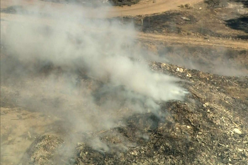 An aerial shot of smoke billowing from a rubbish tip.