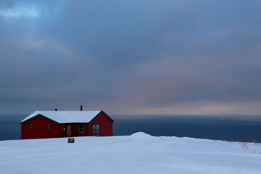 A house overlooks the ocean on the isolated archipelago of Svalbard, deep in the Arctic Circle.