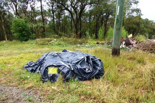 Asbestos illegally dumped in Hawkmount Road at Dora Creek.