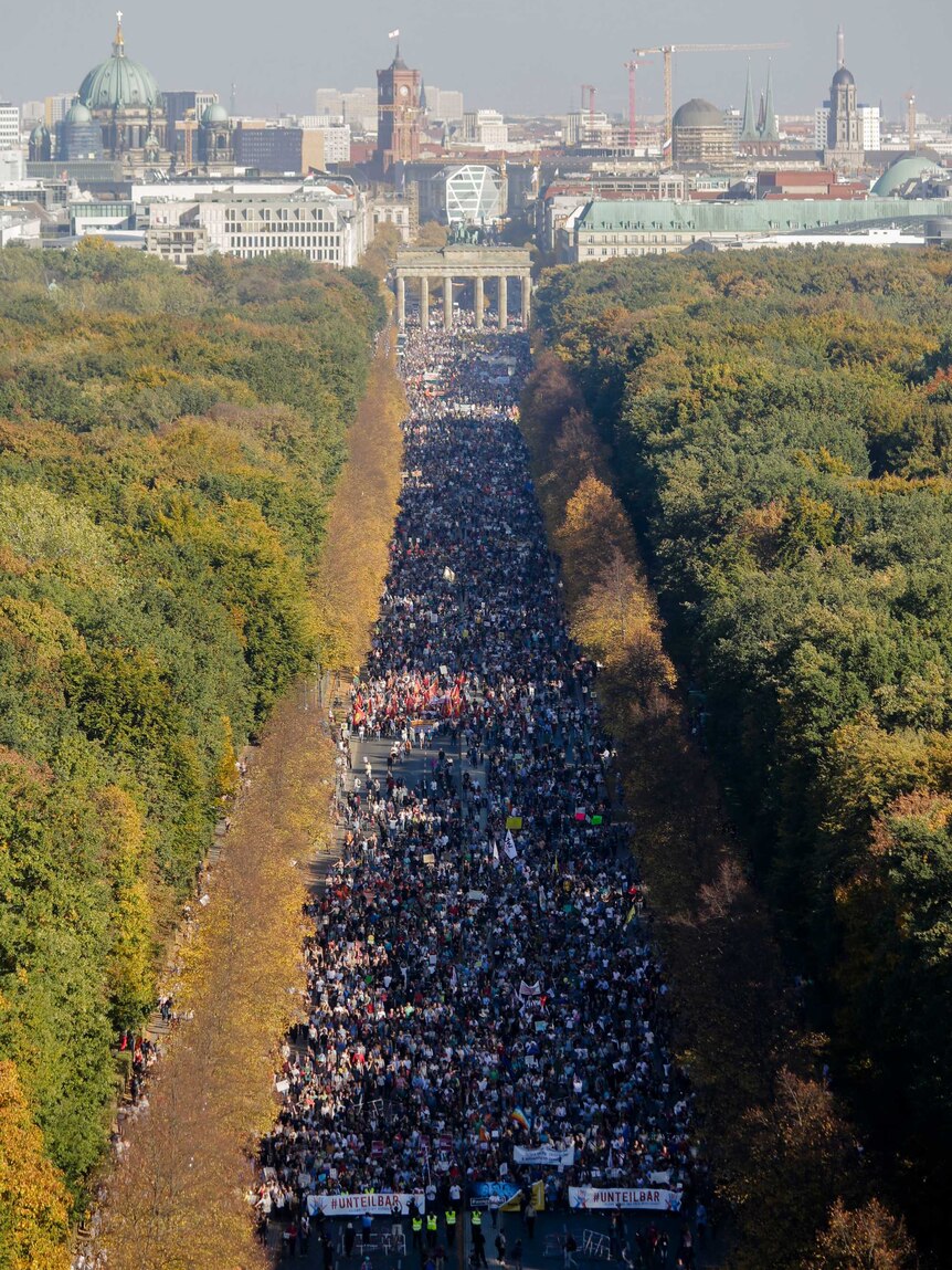 An avenue lined with thousands of people.