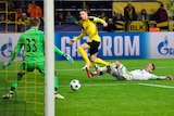 Marco Reus (C), scores Borussia Dortmund's eighth goal against Legia Warsaw in the Champions League.
