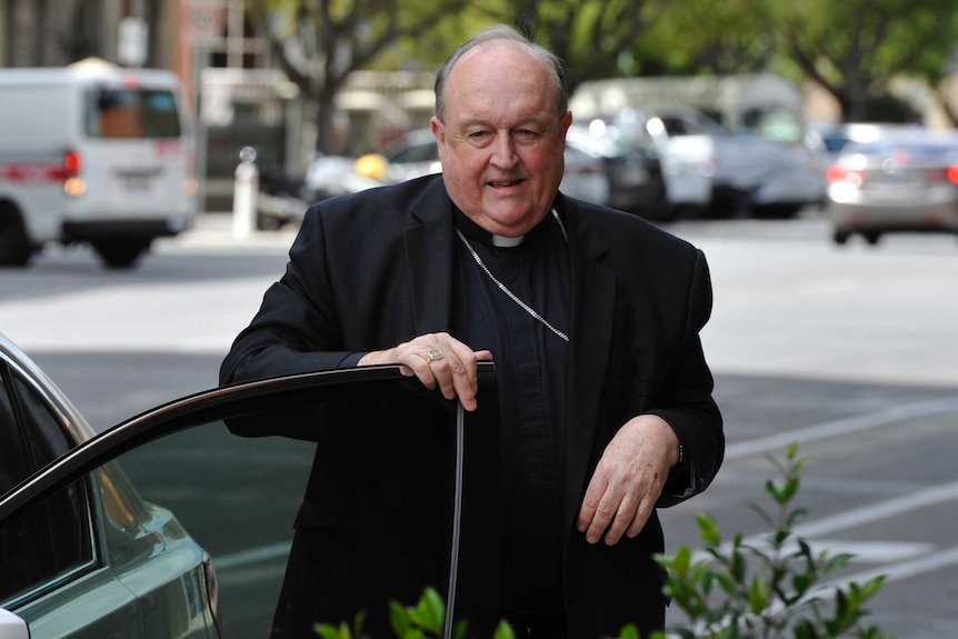 A priest gets out of a car