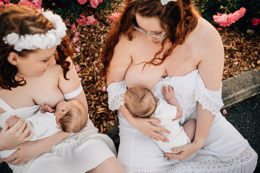 Two women dressed in white breastfeed their babies