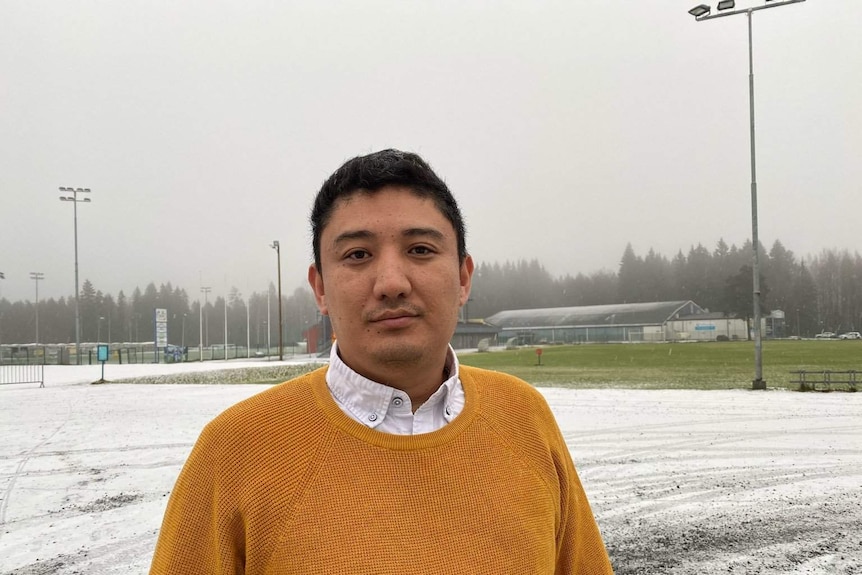 A Uyghur man standing in a outdoor space