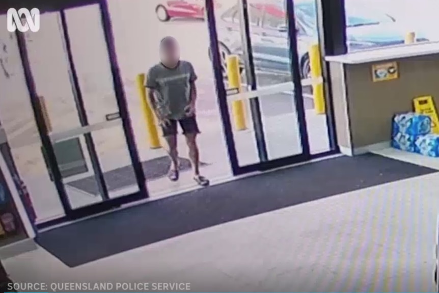 A man entering a service station.