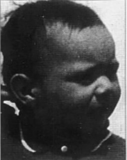 A black and white photo of a child