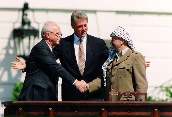 three men stand together and shake hands