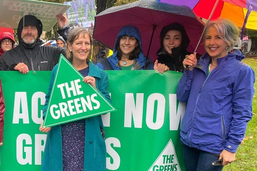 Members of the Tasmanian Greens holding party signs.