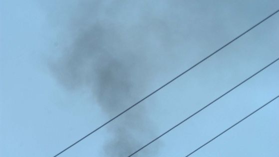 Smoke is emitted from a smoke stack