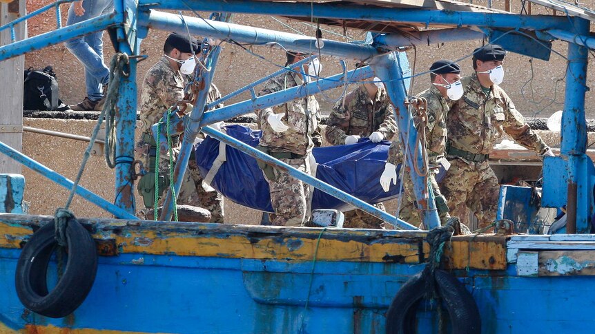 Soldiers carry the body of a victim of a shipwreck off Sicily in Lampedusa harbor. More than 200 are still missing, 111 bodies have been recovered and authorities say many will never be found. (Reuters:Antonio Parrinello)