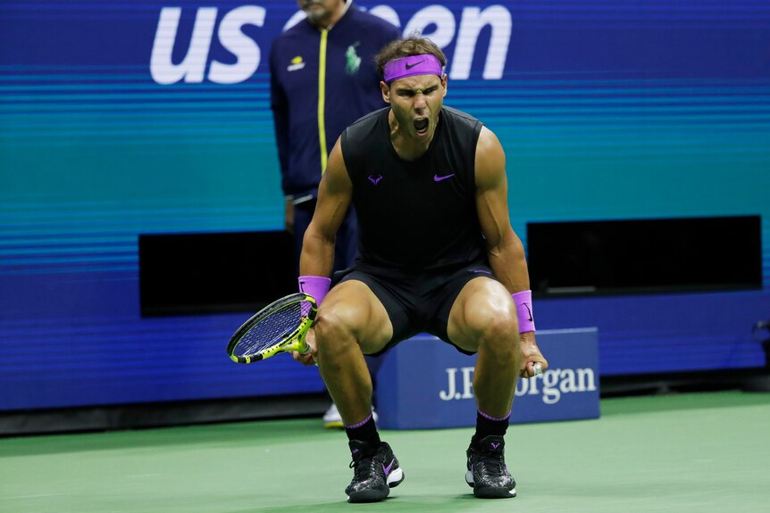 Rafael Nadal bends his knees and clenches his fists and screams