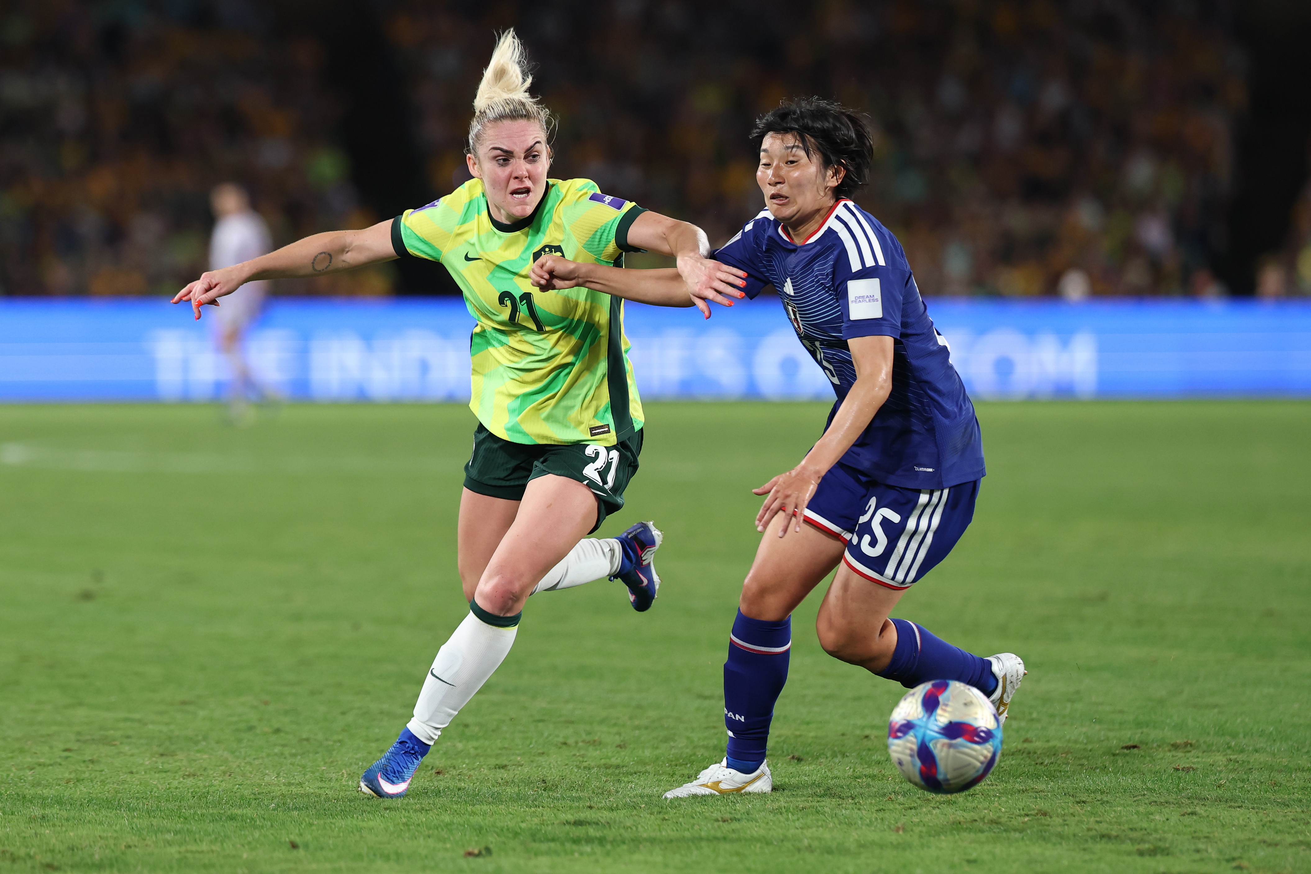 Matildas player Ellie Carpenter tussles with a player as she tries to win the ball