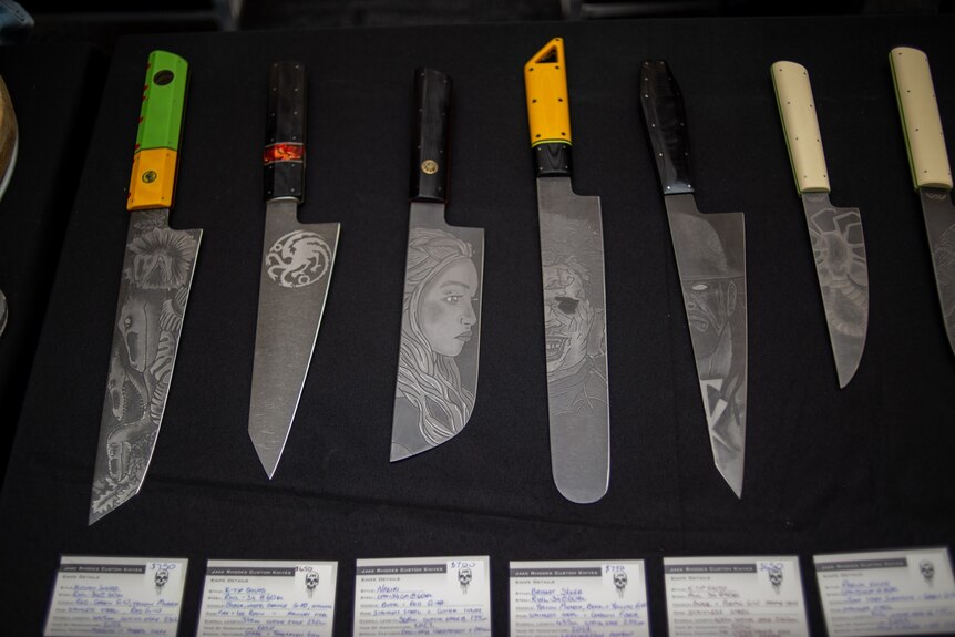 A row of custom knives.
