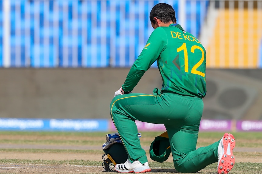 South Africa batsman Quinton de Kock kneels