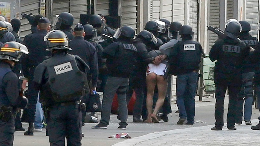 Police take away suspect after Saint-Denis raids