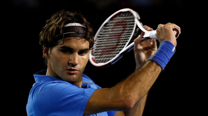 Roger Federer prepares to hit a backhand