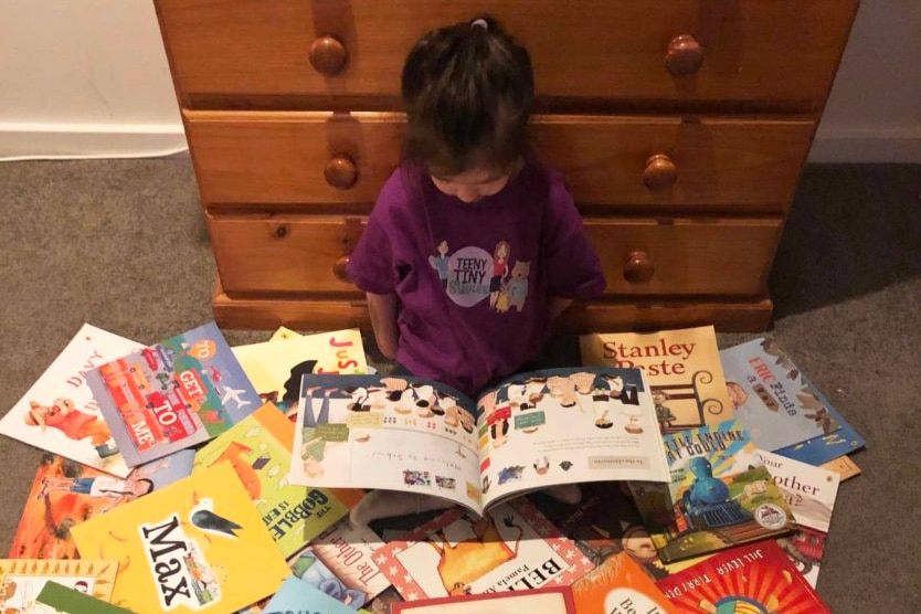 a child surrounded by books