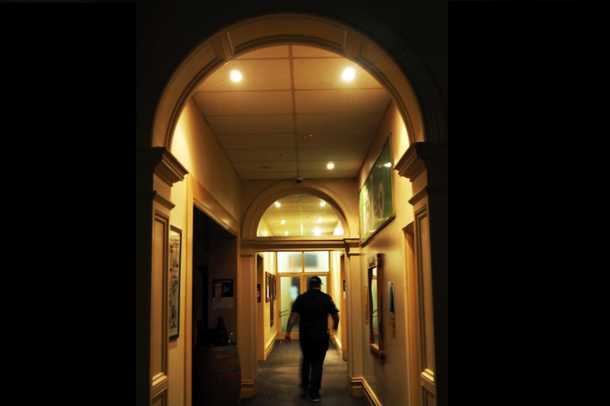 Man in brightly lit corridor
