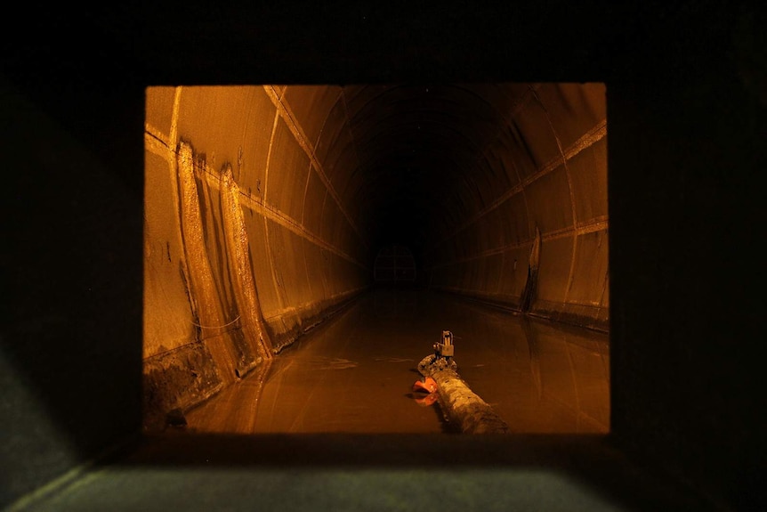 A photo of a well-lit cavernous oil tank.