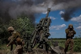 Ukrainian troops fire a Howtizer. 