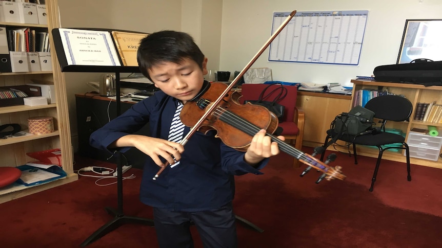 Ten year-old Melbourne violin prodigy Christian Li plays his instrument