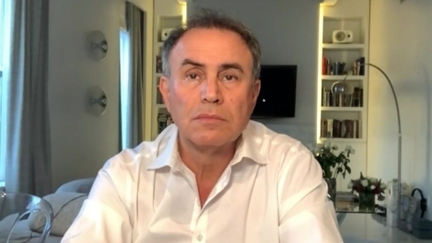 Nouriel Roubini sits in a room