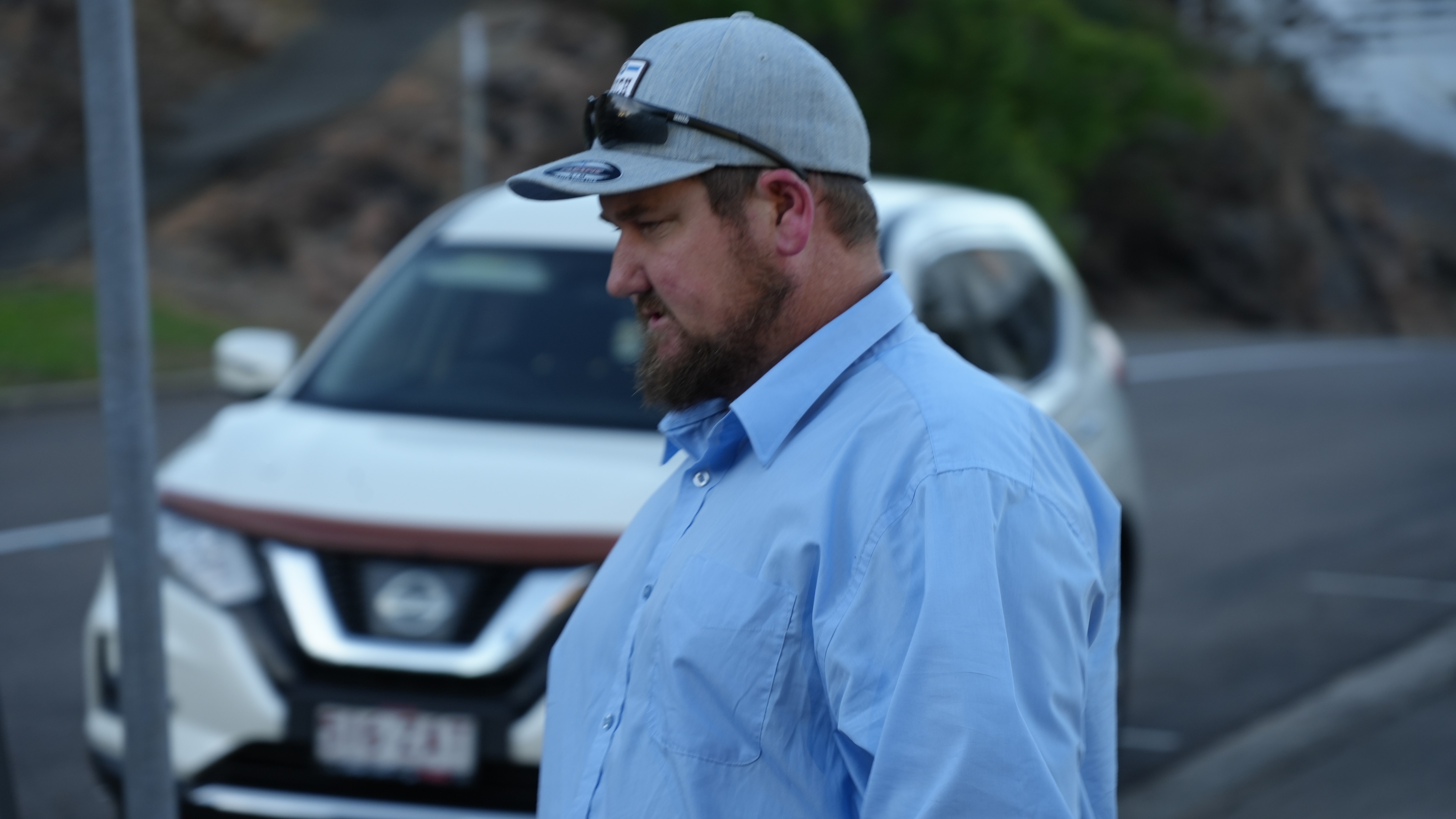 A man in a cap walking away.