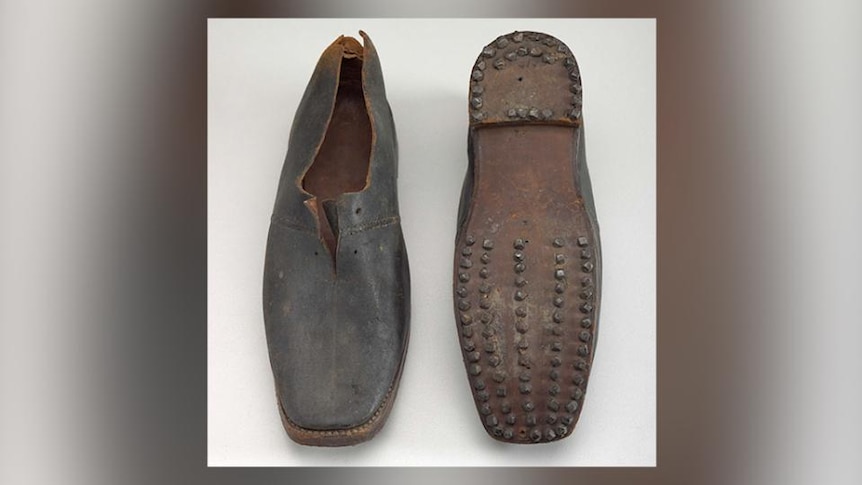 Two convict-made shoes, one upturned to show sole