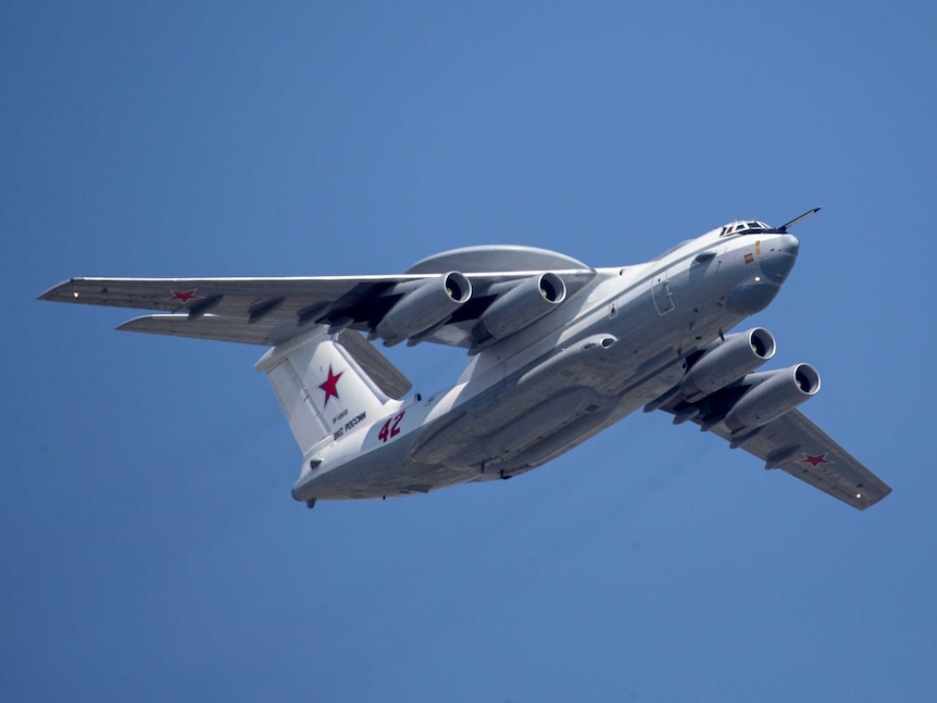 A Russian military plane flies in the sky at daytime