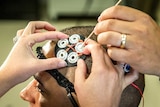 Electrodes being placed on a man's scalp.