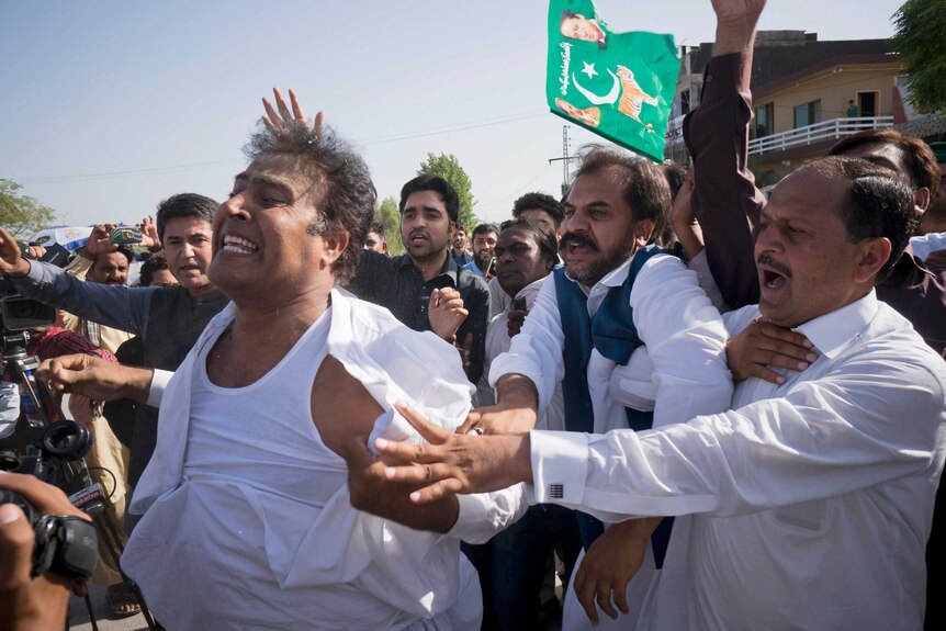 Supporters of former Pakistani Prime Minister Nawaz Sharif react outside a court