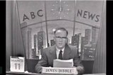 Black and white photo of James Dibble at ABC News desk with March 11 and his name on desk.
