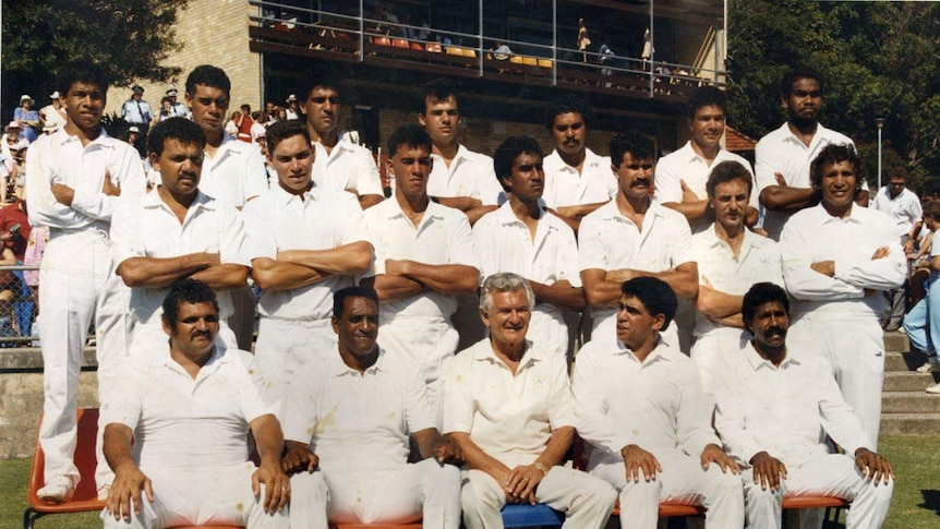 Aboriginal cricketers of 1988 pose on the pitch for a group photo with then-Prime Minister Bob Hawke.