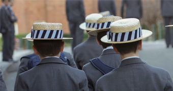 Male students in grey blazers and boater hats