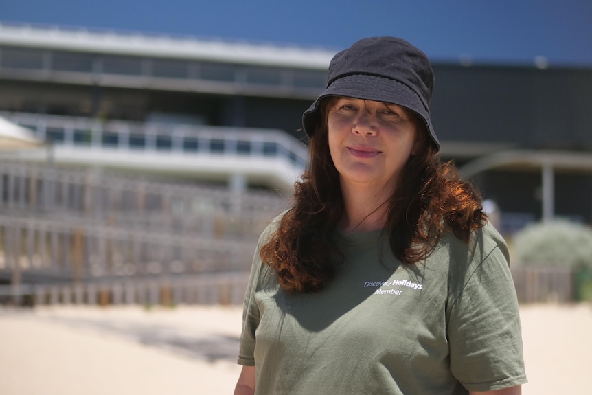 A woman in a hat and t-shirt.