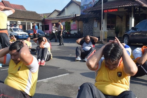 Indonesian police exercising during a weight loss program