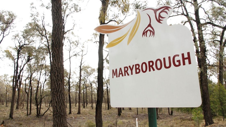 A white sign that says Maryborough standing in the bush.
