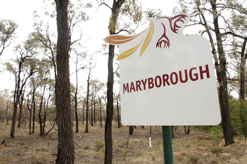 A white sign that says Maryborough standing in the bush.