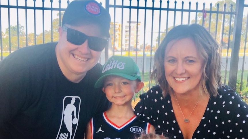 A picture of two women and two children smiling at the camera.