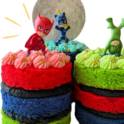 Three multi-tiered cakes, one red, one blue and one green with characters of the same colour on them 