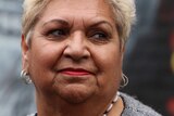 A portrait of an Aboriginal woman with short blonde hair.