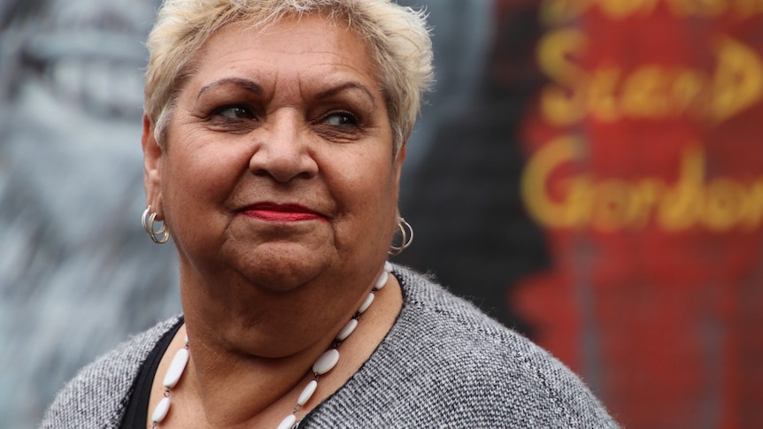 A portrait of an Aboriginal woman with short blonde hair.