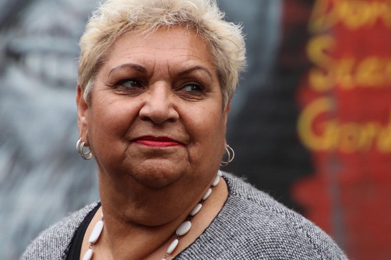 A portrait of an Aboriginal woman with short blonde hair.