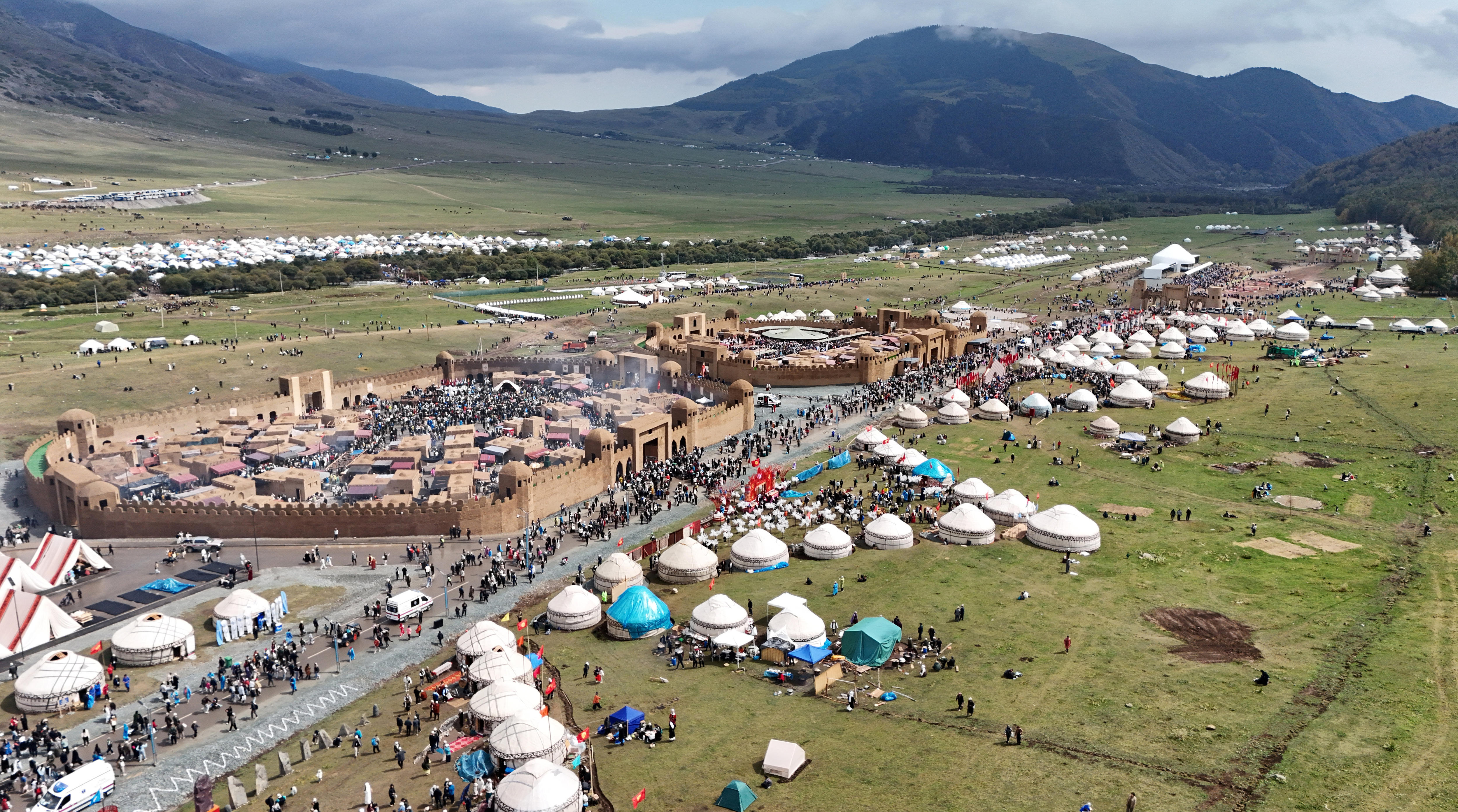 white yurts in a field.